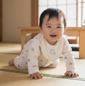 赤ちゃんの笑顔のハイハイの写真。たくさんハイハイをすると腕や連携する神経とつながり食事の腕を動かすことに繋がります。